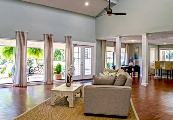 a living room filled with furniture and a large window
