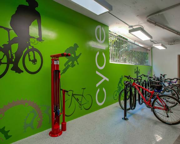 a group of bikes parked in front of a green wall at 430 Kelton, Los Angeles