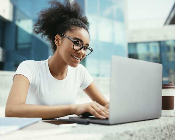 a woman sitting at a table using a laptop computer at 430 Kelton, Los Angeles, CA