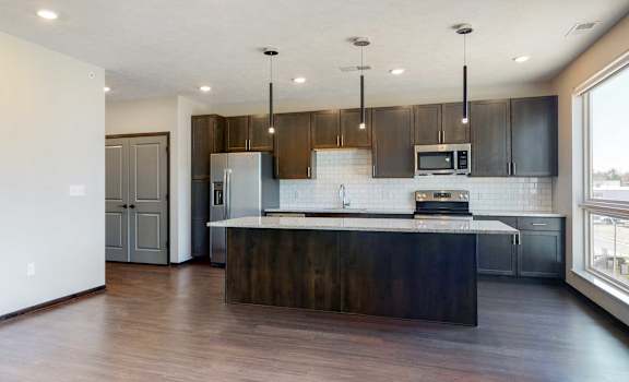 Spacious living-dining space connected to the kitchen in this open concept Melody floor plan at Haven at Uptown in Lincoln, NE