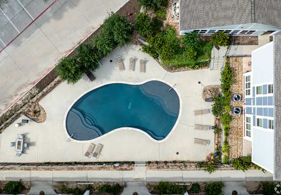an aerial view of a swimming pool in the middle of a building