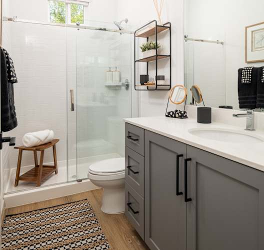 A bathroom with a toilet, sink, and shower.