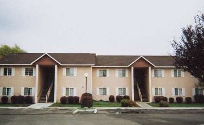 an apartment building with a street in front of it