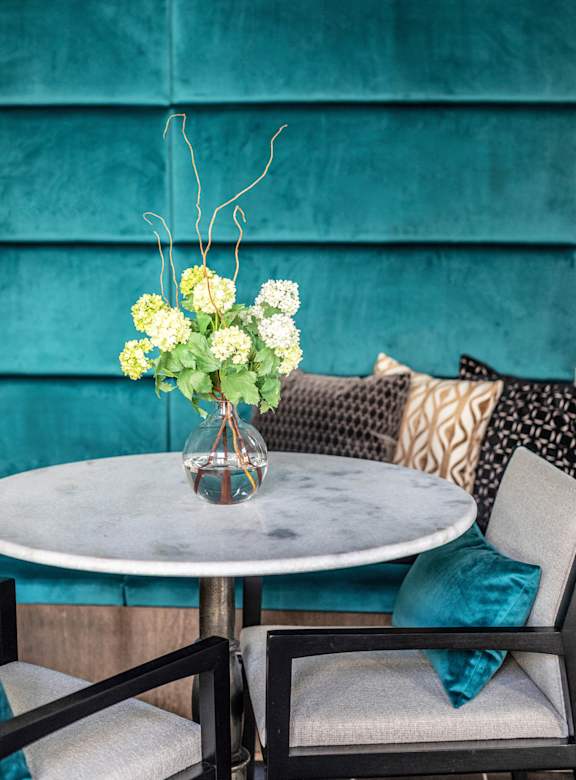 A table with a vase of flowers on it.