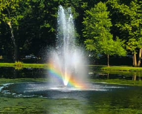 a fountain with a rainbow in the middle of it