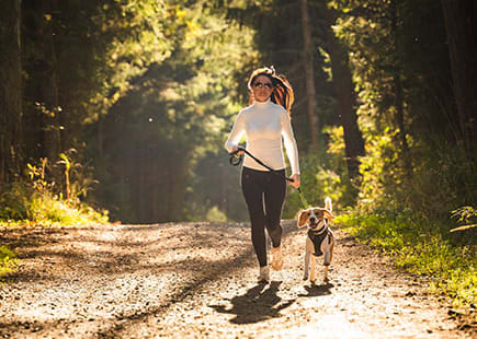 Woman and dog on a walking trail