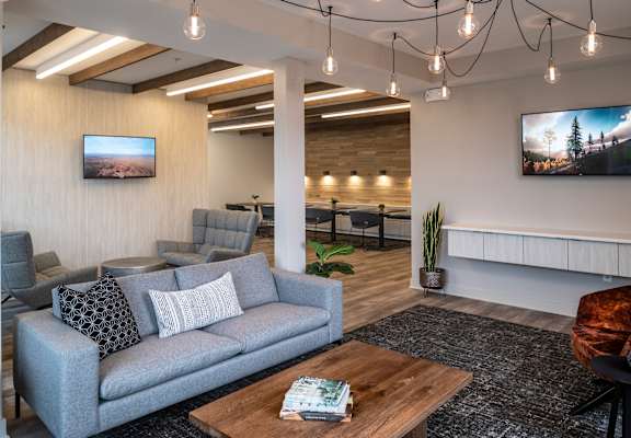 a living room with couches and chairs and a table