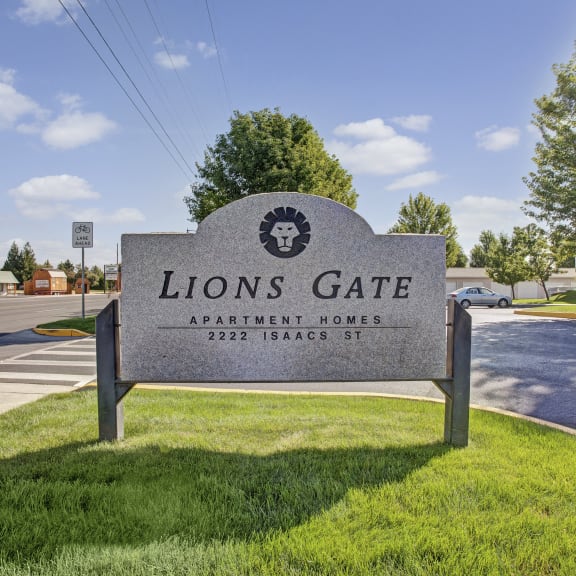 a sign for lions gate at the corner of a street