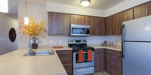 a kitchen with stainless steel appliances and white counter tops