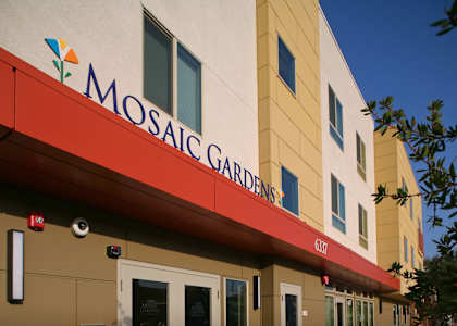 the outside of amoscal gardens building with a red awning