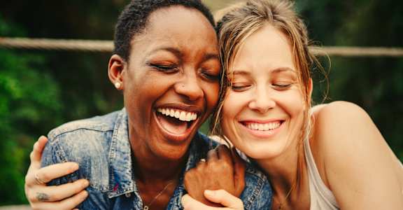 a woman and a girl laughing together