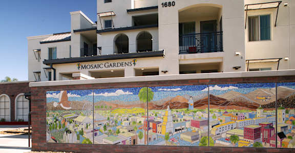 a mural on a wall in front of a building