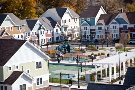 a neighborhood with a basketball court in front of houses