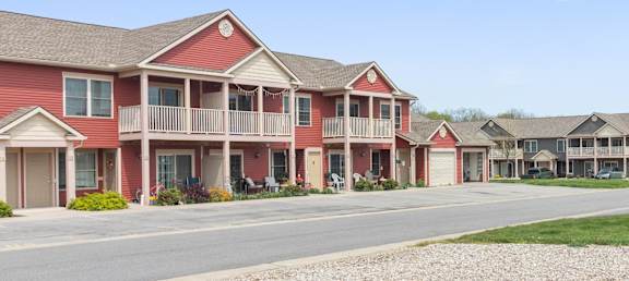 a row of red houses next to a street