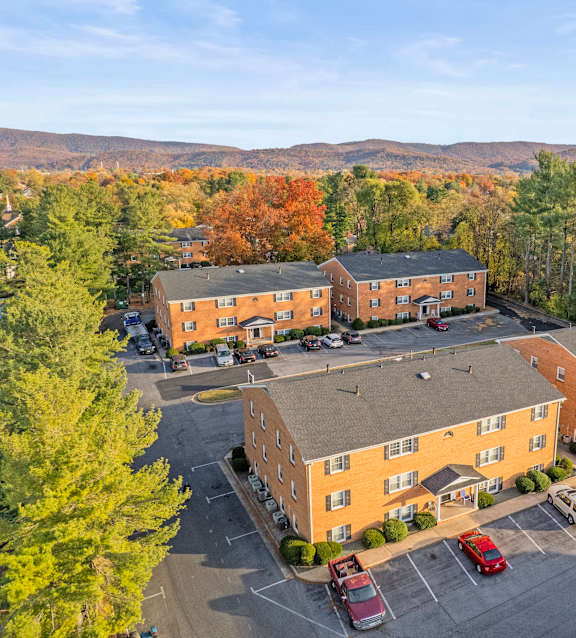 A large open parking lot with a picnic table in the middle.