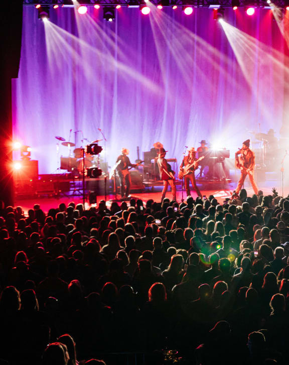 a crowd of people watching a band on a concert stage at The Pearl, Indiana 46802