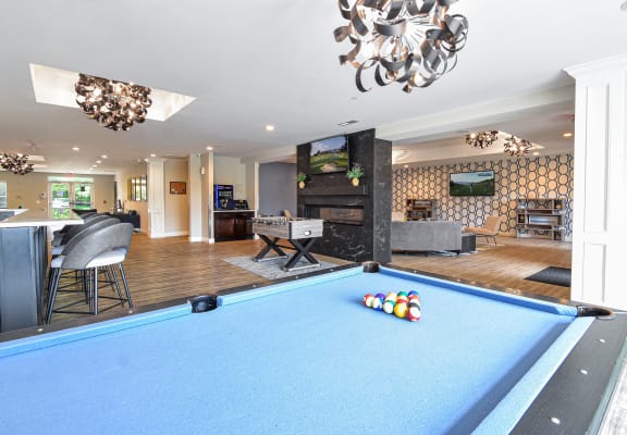 a game room with a pool table and a bar at Mirada Apartments, Lewis Center
