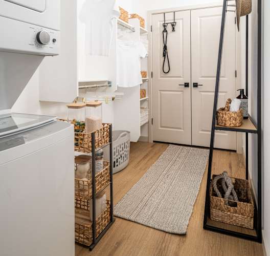 A white oven sits next to a white fridge in a small kitchen.