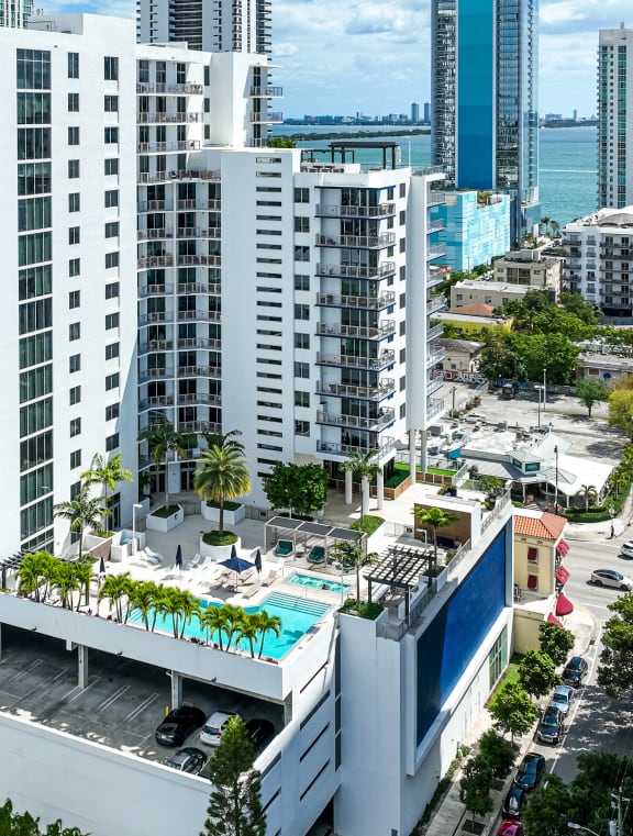 an aerial view of a city with tall buildings and a pool