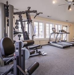 a gym with exercise equipment and windows