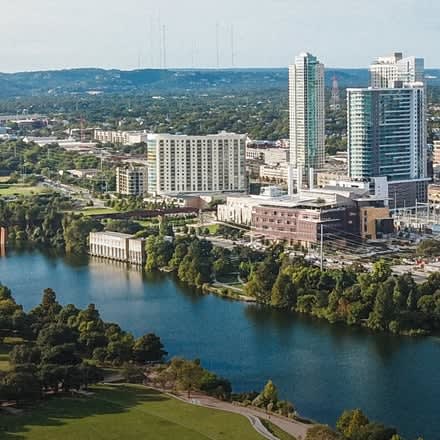 an aerial view of a city with a lake
