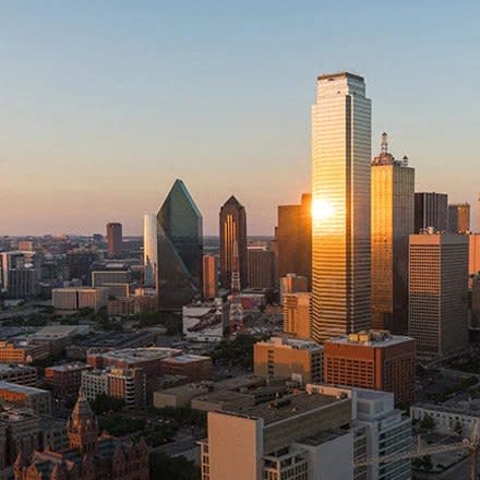 a sunset view of a city skyline with skyscrapers