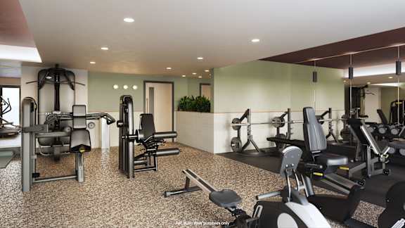 A gym with treadmills, exercise bikes, and a rowing machine.