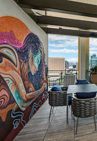 A modern kitchen and dining area with a view of the city.