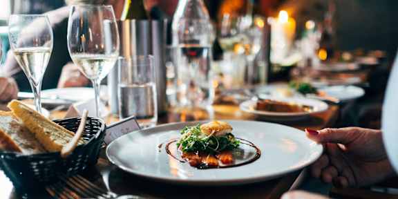 A person is holding a plate with food on it.