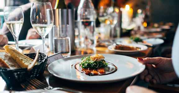 A person is holding a plate with food on it.