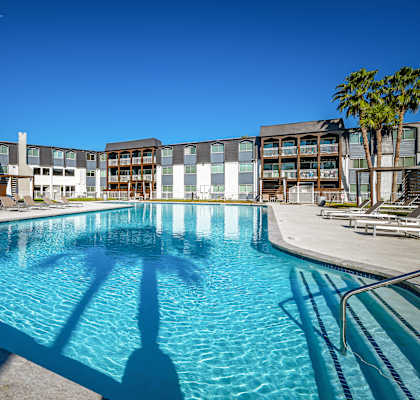 a large swimming pool with a building in the background