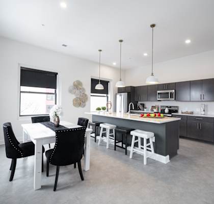 A modern kitchen with a dining table and chairs. at The Annex Apartment, Buffalo, NY, 14222