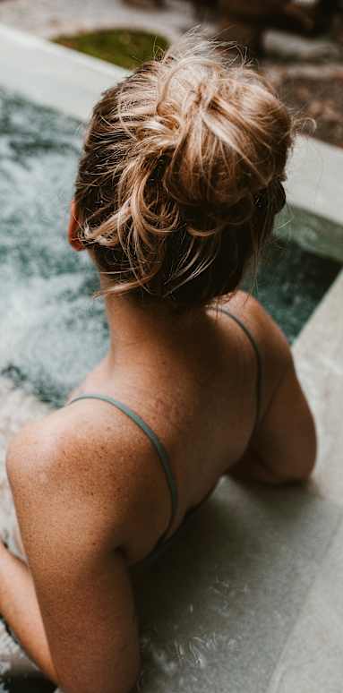 Woman relaxing in hot tub at The Revival, Salt Lake City