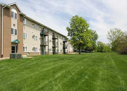 Apartment complex with a green lawn in front.