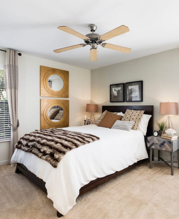 a bedroom with a bed and a ceiling fan at Whisper Lake Apartments, Winter Park, 32792