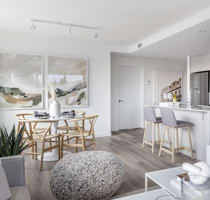A modern living room with a dining table and chairs.