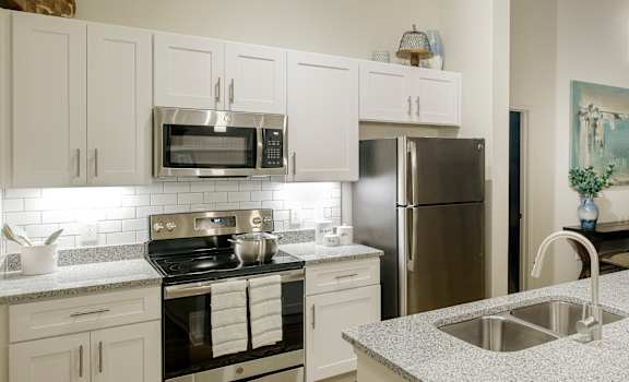 A kitchen with stainless steel appliances at Lofts at Zebulon, Macon, GA, 31210