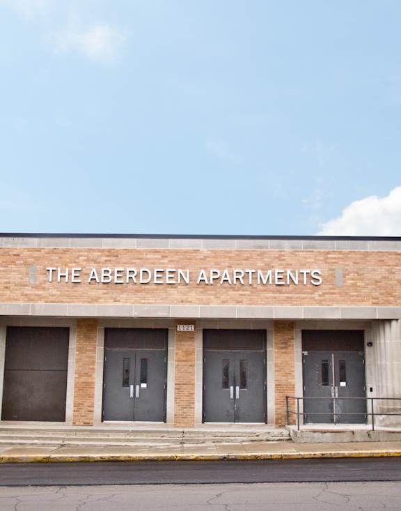 The Aberdeen Apartments is a brick building with three doors.
