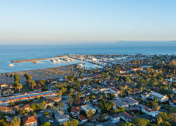 A coastal town with a pier and a clear sky.