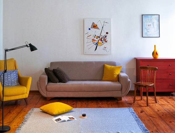 a living room with a couch and a chandelier
