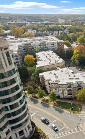 A parking lot with cars and apartment buildings in the background.