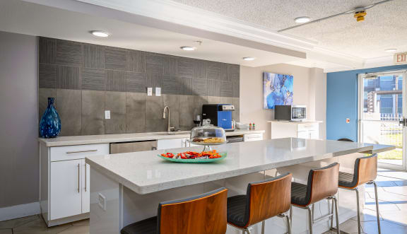 a large lobby with blue chairs and a glass table