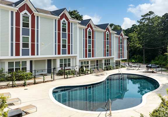 a swimming pool in front of a building with a pool