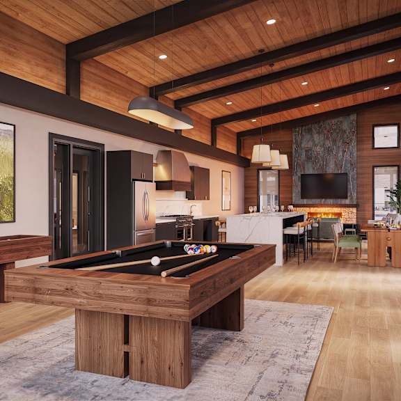 A billiard table is in the middle of a room with a wooden floor and ceiling.