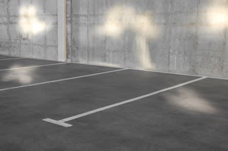 an empty indoor tennis court with lights on the wall at Southpark on Whyte, Edmonton, AB