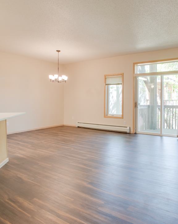 A kitchen with wooden cabinets and a white oven. at Eighth Street Manor  Apartments, Fargo, ND