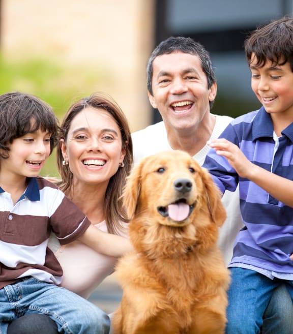 A happy family with their dog at Terracina at Wildhawk, California, 95829