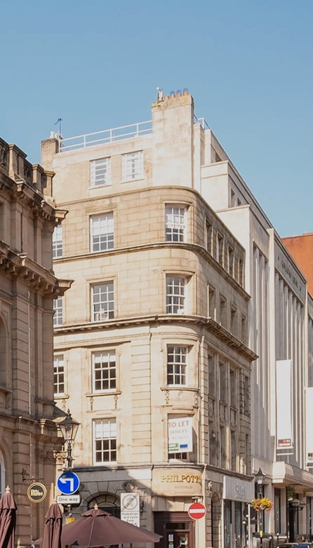 a city street with tall buildings and people walking