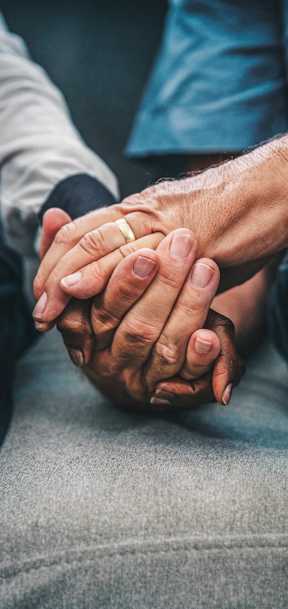 Image of two people holding hands