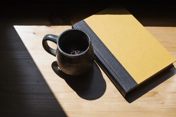 Coffee Mug With Book at Cypress Meadows Senior Apartments, Ventura, 93003